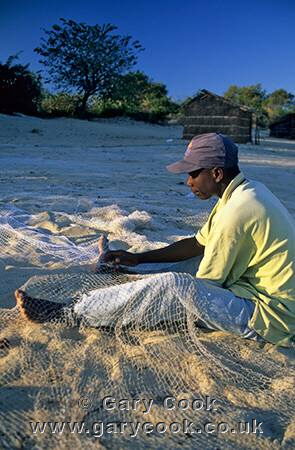 Fishermen mending their nets, Lake Malawi near Kande, Malawi